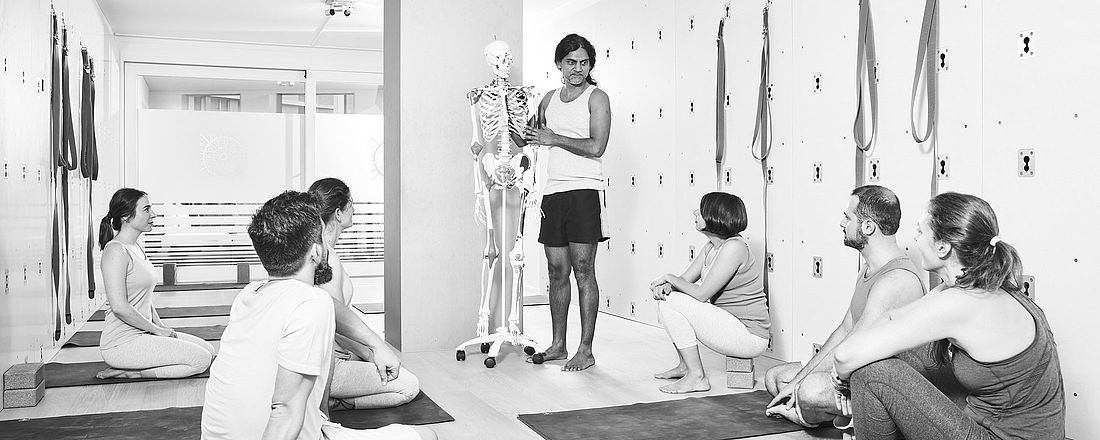 Alignment Yogalehrer Ausbildung im Yoga Studio von the yoga place in Zürich.  Joey erklärt etwas am Skelett.